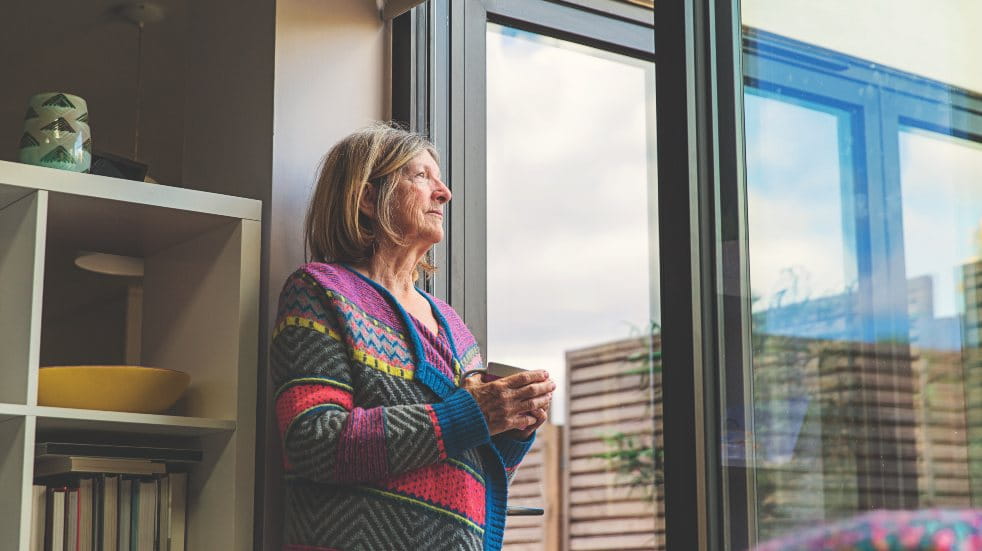 woman standing in doorway with tea